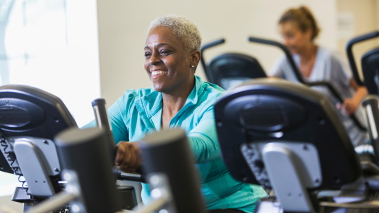 Smiling woman on exercise bike