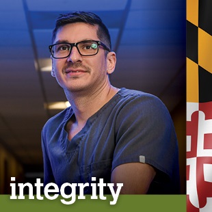 man wearing scrubs and glasses with word integrity at the bottom