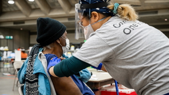 Woman receiving the COVID vaccine at the Baltimore Convention Center