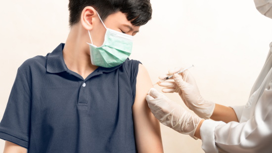 Boy getting a COVID vaccine