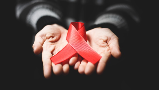 Pair of hands holding HIV ribbon