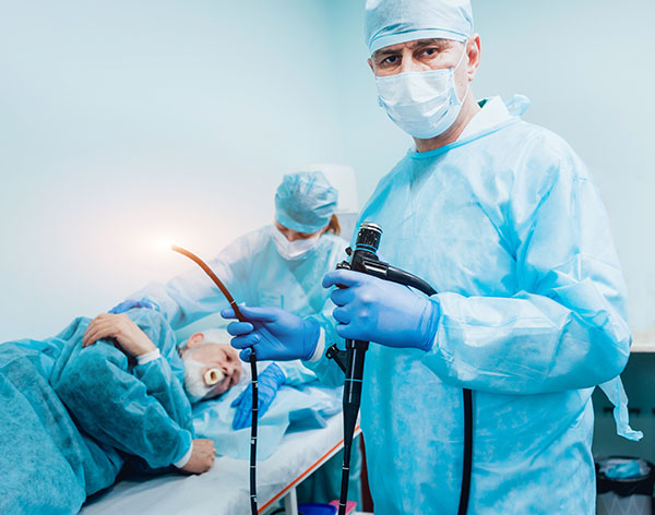 Provider holding endoscopy while patient lays on table