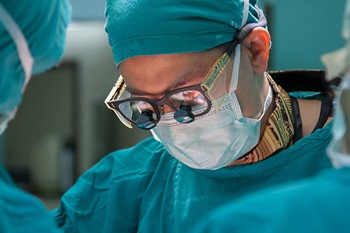 Close up of provider's face as he performs surgery in operating room