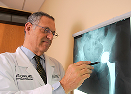 Orthopaedic surgeon Dr. Hal Crane reviews an x-ray
