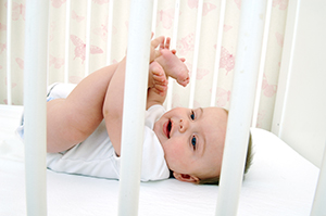 Happy-baby-in-crib-safe-sleep.jpg