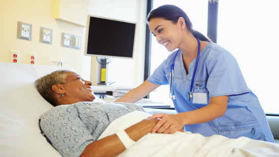 Patient in Hospital Bed Talking with Physician