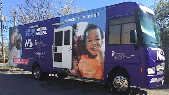 photo of the mama and baby mobile health unit - a purple bus