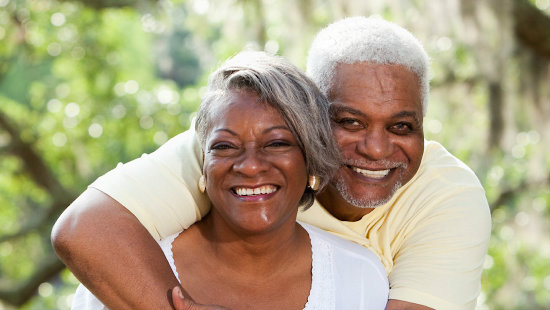 stock photo of man and woman hugging and smiling