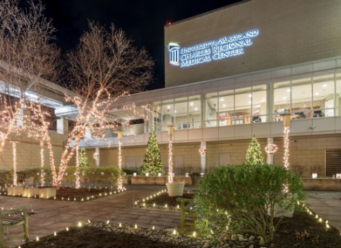 Christmas lights decorating the exterior of the UM Charles Regional Medical Center building