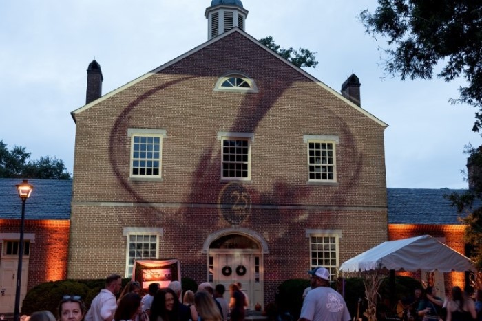 brick building at wine tasting event location with the number 25 projected on the building