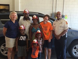 Family poses with first responders at reunion after car crash
