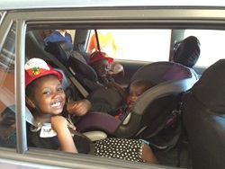 photo of Ngassam, Elijah and Moses Njike in their new car seats