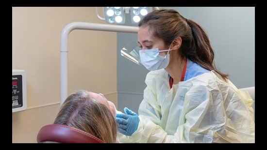 A dentist examining a patient's teeth.