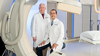 Interventional Cardiologists Dr. Etherton and Dr. Sardi are pictured in the Cath Lab.