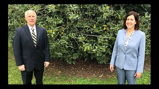 From left are Ken Kozel, president and CEO of University of Maryland Shore Regional Health and Sara Rich, president and CEO of Choptank Community Health System standing on a patch of grass, six feet apart.