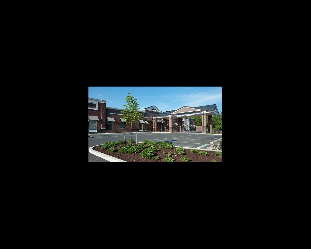 UM Shore Medical Pavilion at Easton is shown, amidst a blue sky and fresh landscaping.