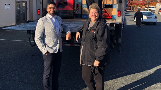 Arvin Singh and Jennifer Small stand next to a Maryland Food Bank truck at site in Cambridge, Maryland.