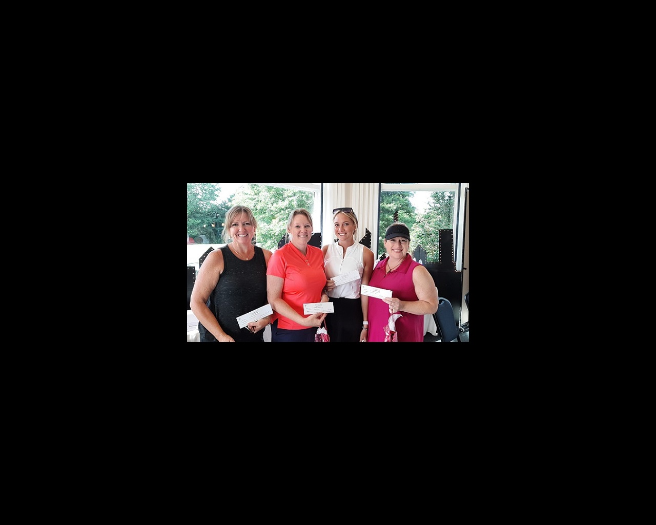Four women stand side by side and smile for the camera. They just completed participating in the Chester River Health Foundation's annual Golf Tournament.