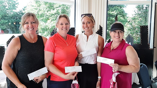 Four women stand side by side and smile for the camera. They just completed participating in the Chester River Health Foundation's annual Golf Tournament.
