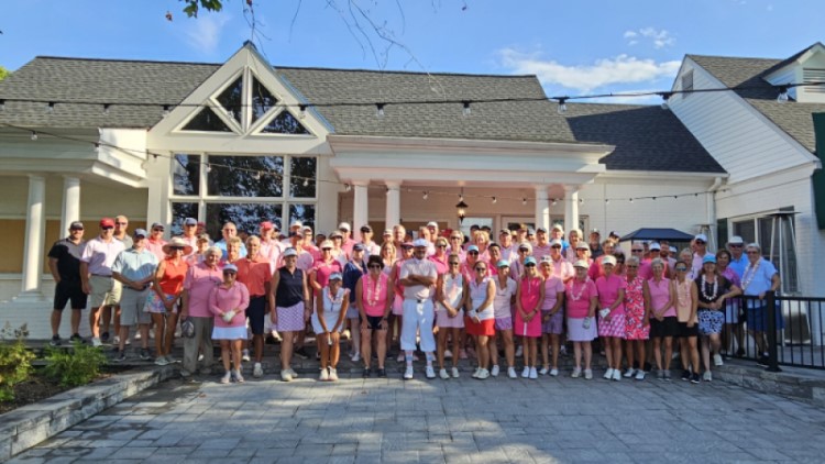 A group of about 90 Chester River Yacht and Country Club members, and their guests, stand in a large group for a photo.
