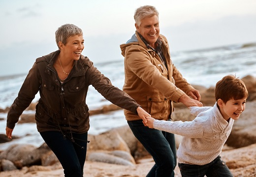 older couple with young boy at the beach