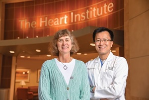 photo of the Heart Institute doctor posing with a female patient