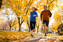 two people running with trees in the background