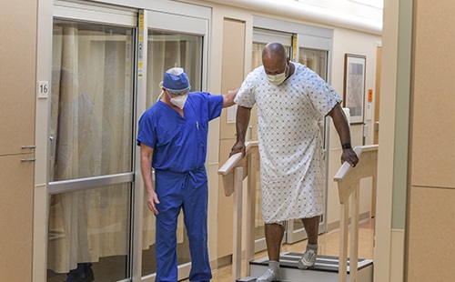Rehabilitation provider providing support to a patient during therapy on stairs