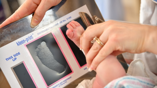 Nursing recording a footprint of a newborn