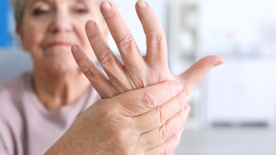 Woman rubbing her hand in pain