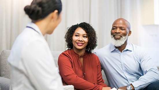 Patient and family member consulting with doctor