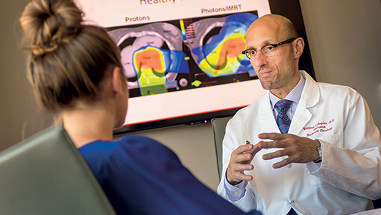 UMMC radiation oncologist William Regine, MD, speaks with a patient