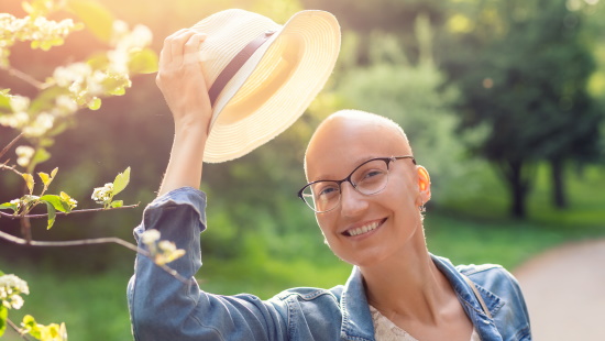 Bald woman tipping her hat