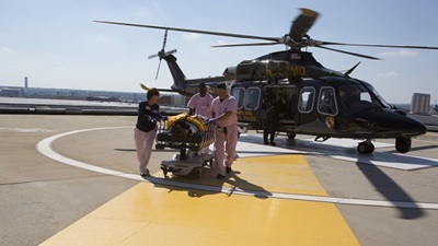 Shock Trauma team pushing a stretcher from the helicopter on the helipad
