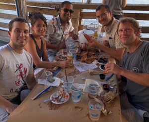 ortho trauma fellows sitting around the table eating crabs together