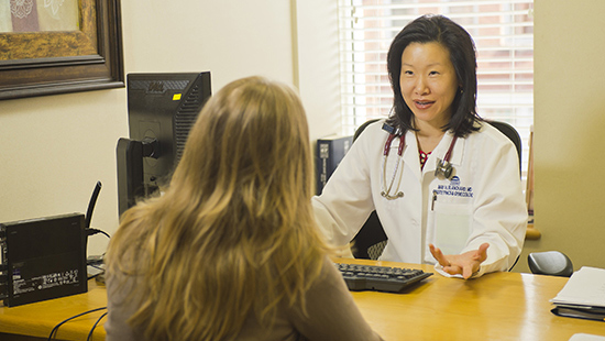 May Blanchard, MD, speaking with a patient