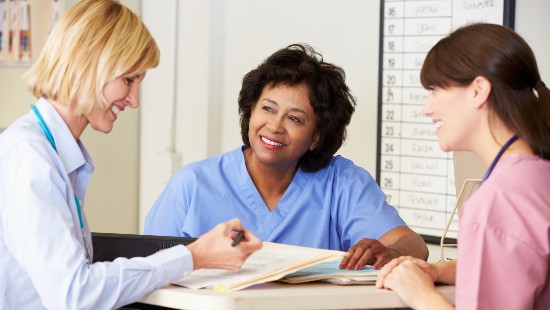 Nurses reviewing notes with physician