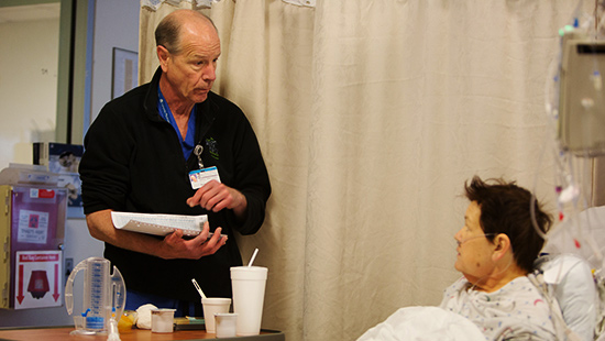 Cardiac surgeon Bartley Griffith, MD, chats with a patient
