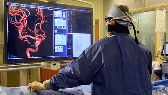 An interventional radiologist performs a procedure