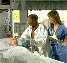 Photo of a medical professionals adjusting a patient's breathing tube