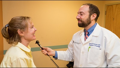 Dr. Dan Harrison with a patient