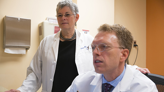 Parkinson's Disease Research and Clinical Trials | Lisa Shulman, MD, and F. Rainer von Coelln, MD, look over a patient's case