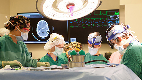 Surgeons performing brain surgery