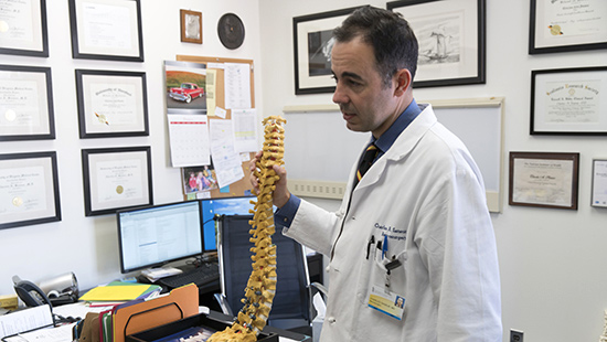 Spine Care - Charles Sansur, MD, in his office