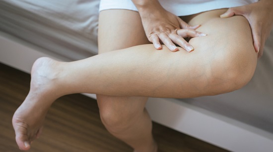 Woman holding painful knee