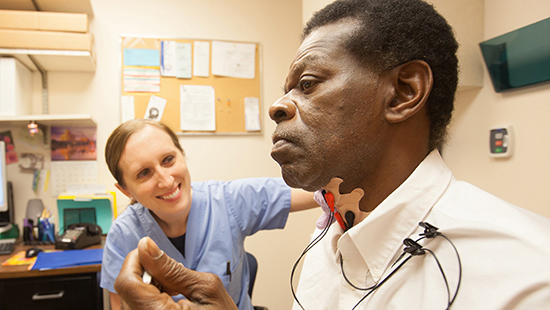 A University of Maryland Medical Center speech pathologist works with a patient