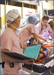 Members of the shock trauma staff work on a patient