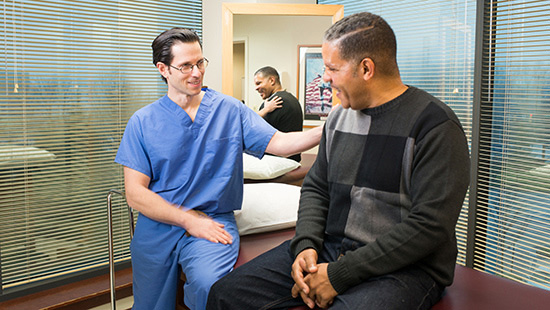 UMMC spine surgeon Steven Ludwig, MD, chats with a patient
