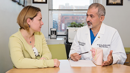 Dr. Ozhan Turan speaks with a patient