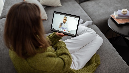 Woman having a telehealth visit on her tablet